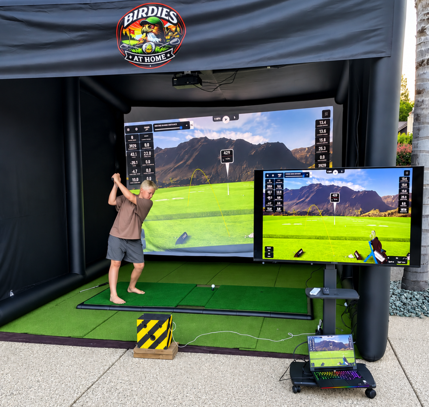 Man playing indoor golf simulator setup.